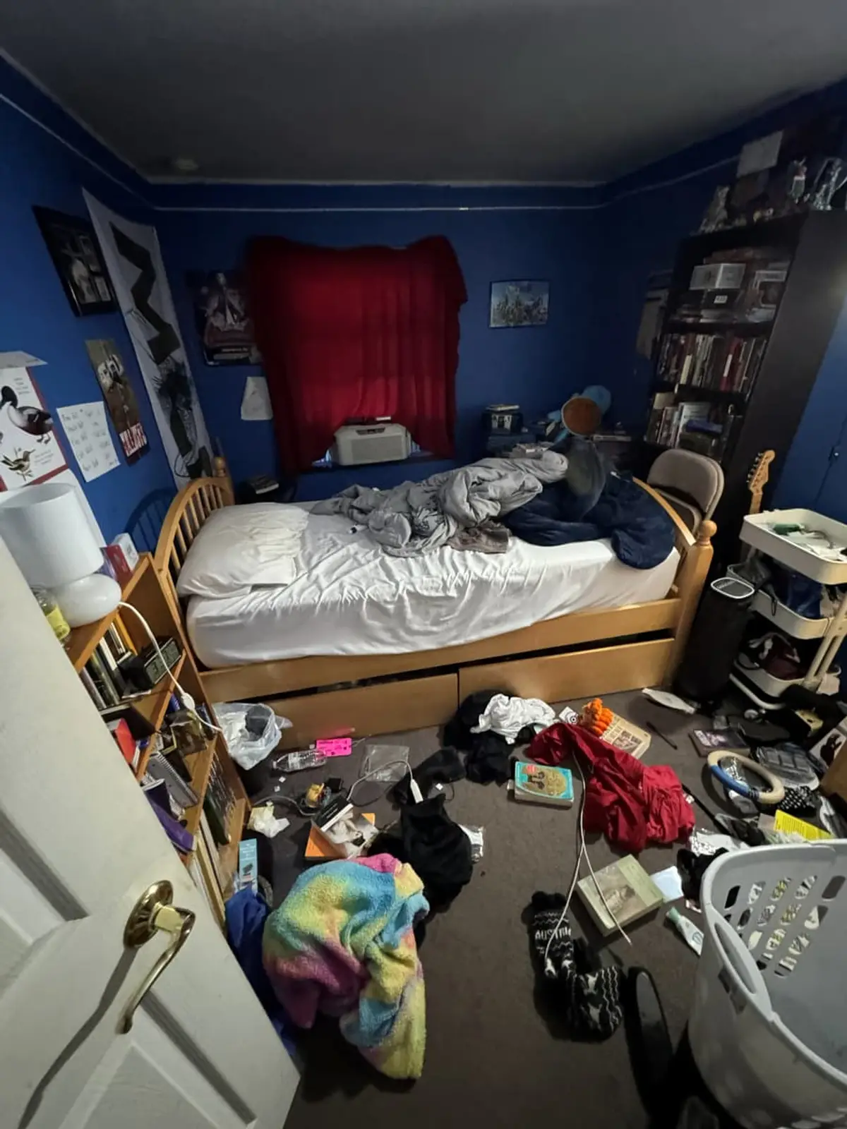 Selling in the Medford housing market: blue bedroom with clothes and clutter across the floor