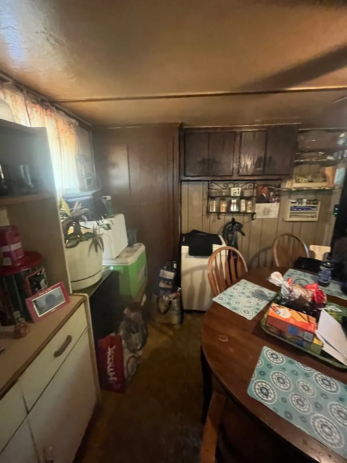 Selling a house with multiple heirs in Medford: dated kitchen with dark cabinets and a round table